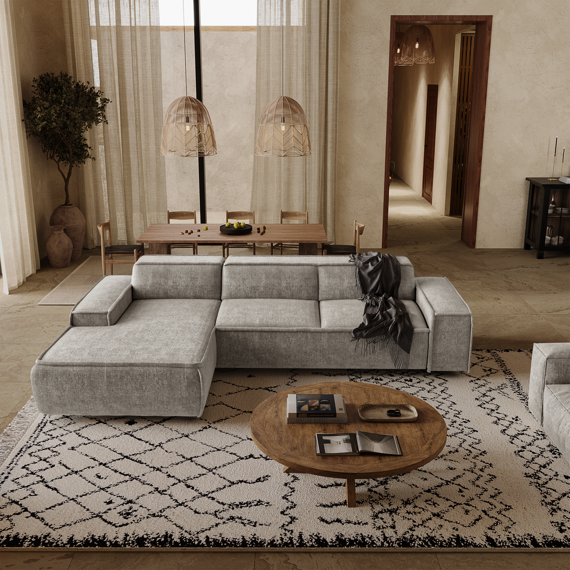 Canapé d'angle gris clair structurant un salon spacieux au style naturel et chaleureux