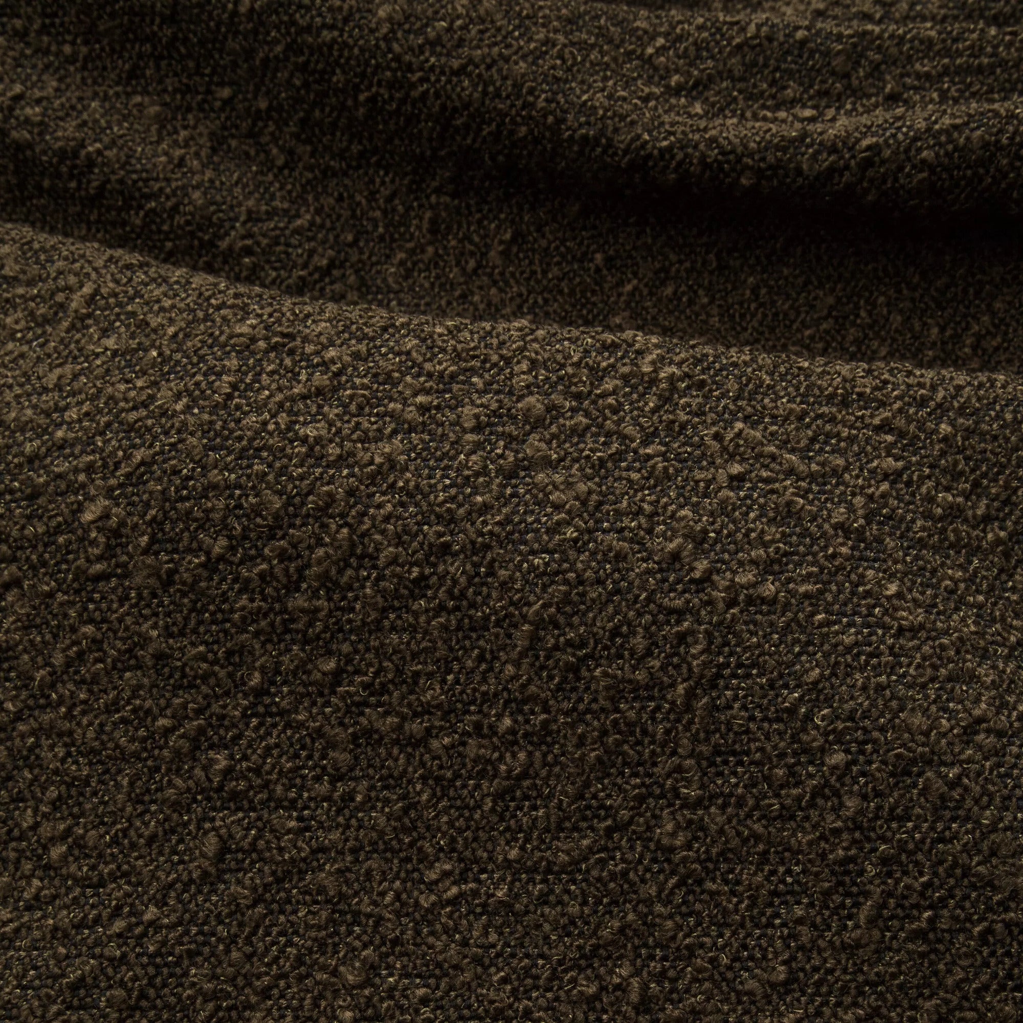 Zoom d'un tissu bouclette en vert olive